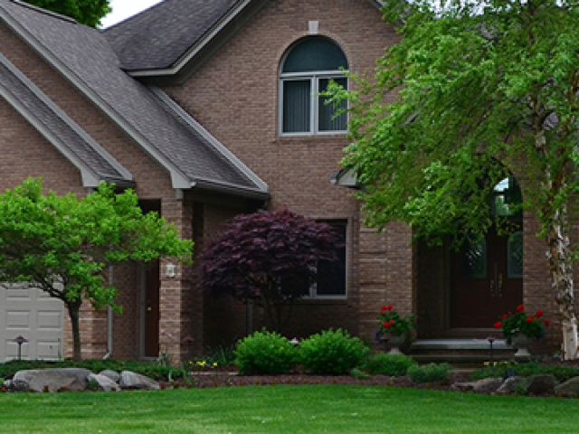 Front yard of St. Clair home with trees